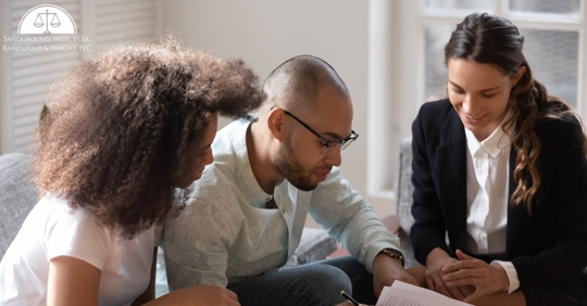 couple going over paperwork with someone else