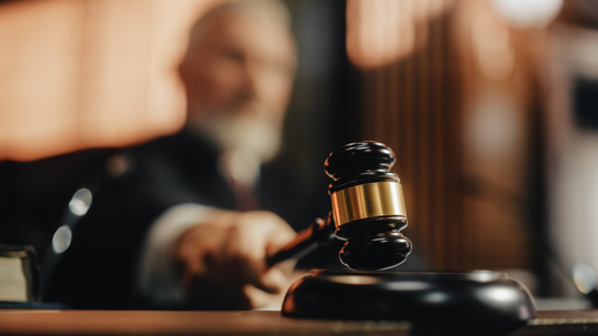 Judge hitting his gavel in the courtroom
